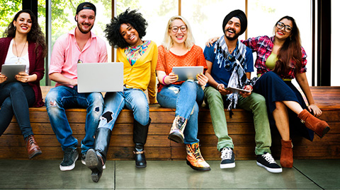 group-of-young-people-with--two-laptops-smiling-for-a-photograph.jpg