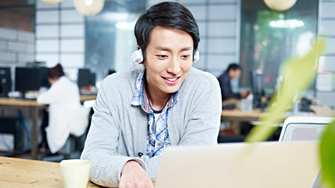 young-man-with-laptop-and-headset-in-the-coworking-space.jpg