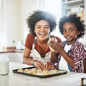 happy women with child cooking on the kitchen 