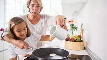 grandma and granddaughter cooking
