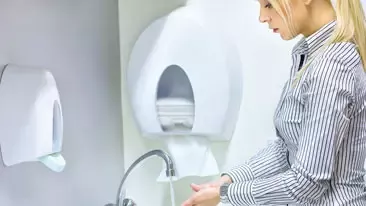 Person washing their hands.